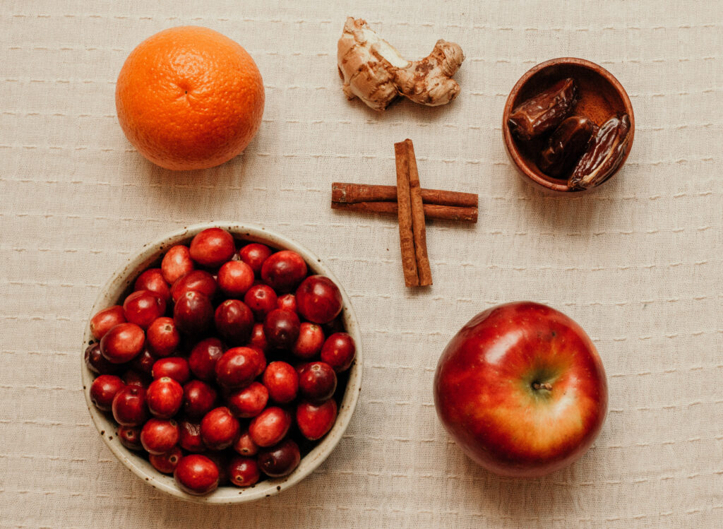 ingredients of cranberry relish laid out on cloth table